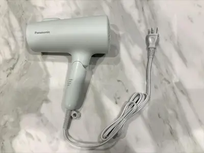 a hair dryer and a whisk on a counter at IGETA HOUSE Shibuya in Tokyo