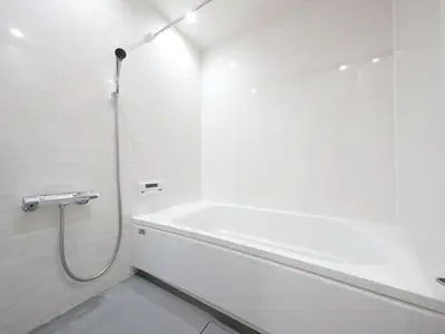 a white bathroom with a tub and a shower at IGETA HOUSE Shibuya in Tokyo