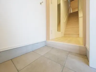 an empty room with a staircase and a tiled floor at IGETA HOUSE Shibuya in Tokyo