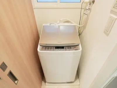 a laptop computer sitting on top of a trash can at IGETA HOUSE Shibuya in Tokyo