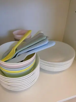 a stack of plates and utensils sitting on a table at Hotel Lien Tokyo2 in Tokyo