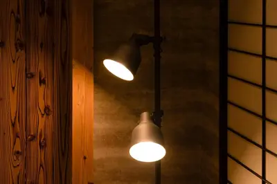 a couple of lights hanging from a wall at \u6771\u4eac\u4e0a\u91ce\u6b65\u884c3\u5206\u72ec\u680b\u522b\u5885 in Tokyo