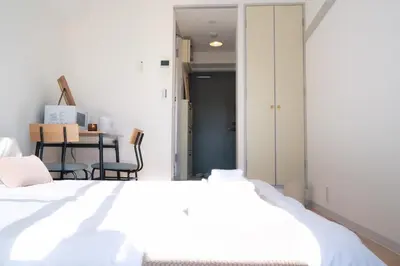 a bedroom with a white bed and a table at Ikebukuro 304 - Twin Room in Tokyo