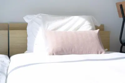 a bed with white sheets and a pillow on it at Ikebukuro 304 - Twin Room in Tokyo