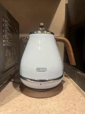 a tea kettle sitting on a counter next to a microwave at ROLES Ryusen 901 in Tokyo