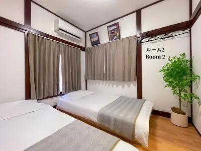 a bedroom with two beds and a potted plant at 7\u6642IN19\u6642OUT # \u6c60\u888b\u738b\u5b50\u8d64\u7fbd\u99c5\u9001\u8fce\u7121\u6599 # \u30f4\u30a3\u30e9\u4e00\u8ed2\u5bb6\u8cb8\u5207# \u99c5\u8fd18\u5206# \u6700\u59276\u540d# 7 00 IN19 00 OUT # Free pick-up at Ikebukuro, Oji, and Akabane Stations # Whole house rental in Tokyo