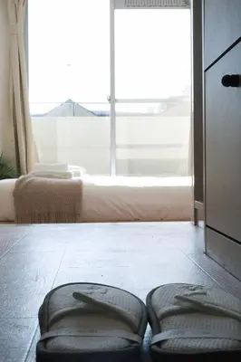 a room with a large window and two stools on the floor at Ikebukuro 311 - Twin Room in Tokyo