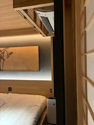 a bedroom with a bed in a small room at Komorebi Rill Hotel HANA in Tokyo