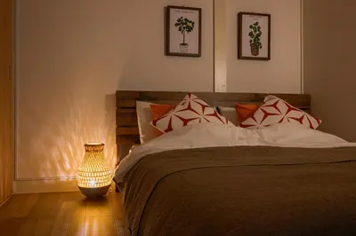 a bedroom with a bed and a vase on the floor at Direct Haneda Access &Onsen 1-min Walk SAMURAI STAY ZEN in Tokyo