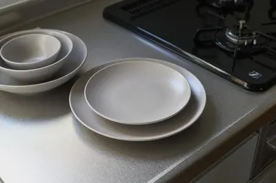 a table with two plates and a phone on a counter at Direct Haneda Access &Onsen 1-min Walk SAMURAI STAY ZEN in Tokyo