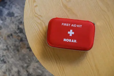 a red first aid kit on a wooden table at Direct Haneda Access &Onsen 1-min Walk SAMURAI STAY ZEN in Tokyo