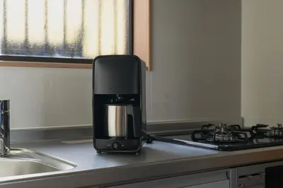 a coffee maker sitting on top of a kitchen counter at Direct Haneda Access &Onsen 1-min Walk SAMURAI STAY ZEN in Tokyo