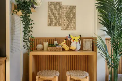a shelf with stuffed animals on it with two stools at Direct Haneda Access &Onsen 1-min Walk SAMURAI STAY ZEN in Tokyo