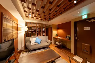 a living room with a couch and a television at \u65c5\u9928\u87a2 in Tokyo