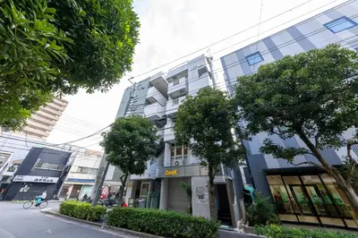 a building on a street with trees in front of it at \u65c5\u9928\u87a2 in Tokyo