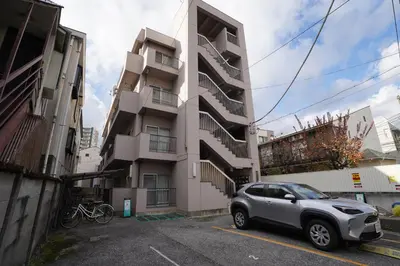 a car parked in a parking lot in front of a building at 302Room 1 Stop from Ikebukuro Entire 33m on 3st Floor 2 Bedrooms for up to 6 Guests 3Minute Walk to Don Quijote in Tokyo