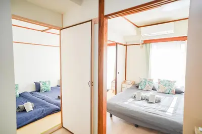 a bedroom with two beds and a mirror at 302Room 1 Stop from Ikebukuro Entire 33m on 3st Floor 2 Bedrooms for up to 6 Guests 3Minute Walk to Don Quijote in Tokyo