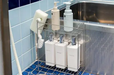 a rack with four white soap dispensers on a wall at TokyoDisneyAkihabara,Entire House,8Ppl,5Bedl60m2 in Tokyo