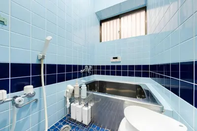 a blue tiled bathroom with a toilet and a sink at TokyoDisneyAkihabara,Entire House,8Ppl,5Bedl60m2 in Tokyo