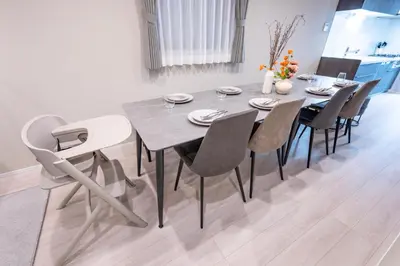 a dining room table and chairs in a room at HOTEL NESTA OSHIAGE Two in Tokyo