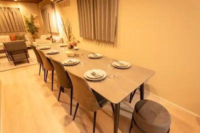 a table in a room with chairs and a dining room at HOTEL NESTA OSHIAGE Two in Tokyo