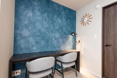 a dining room with a blue wall at HOTEL NESTA OSHIAGE Two in Tokyo