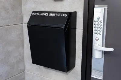 a black box on a wall next to a door at HOTEL NESTA OSHIAGE Two in Tokyo