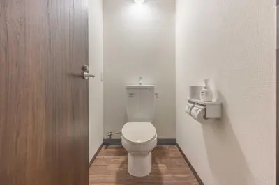 a bathroom with a white toilet with a door at Akabane Dormitory \u8d64\u7fbd\u30c9\u30df\u30c8\u30ea\u30fc - Share Room For Male Only \u7537\u6027\u5c02\u7528\u30c9\u30df\u30c8\u30ea\u30fc in Tokyo