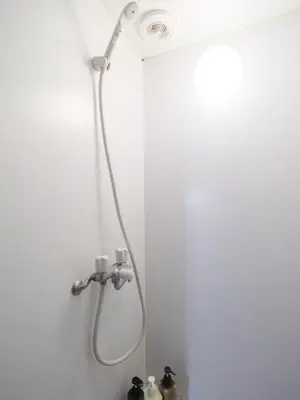 a shower with a shower head in a bathroom at Akabane Dormitory \u8d64\u7fbd\u30c9\u30df\u30c8\u30ea\u30fc - Share Room For Male Only \u7537\u6027\u5c02\u7528\u30c9\u30df\u30c8\u30ea\u30fc in Tokyo