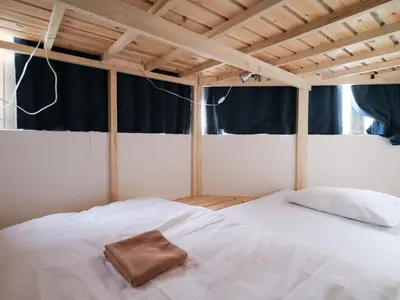 a bedroom with a white bed with a towel on it at Akabane Dormitory \u8d64\u7fbd\u30c9\u30df\u30c8\u30ea\u30fc - Share Room For Male Only \u7537\u6027\u5c02\u7528\u30c9\u30df\u30c8\u30ea\u30fc in Tokyo