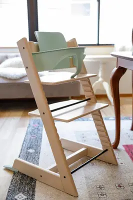 a green chair sitting on a stand in a living room at New - 4 min to Shinjuku! 4 Bedrooms Villa 970 sq ft in Koenji, 10 people, 8 min walk to JR Koenji station - GRADIA Koenji Hotel in Tokyo