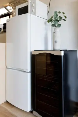 a white refrigerator with a potted plant on top of it at New - 4 min to Shinjuku! 4 Bedrooms Villa 970 sq ft in Koenji, 10 people, 8 min walk to JR Koenji station - GRADIA Koenji Hotel in Tokyo