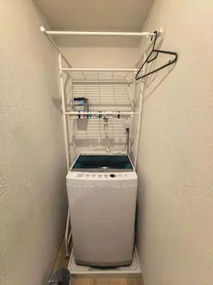 a washer and dryer in a small refrigerator at AYA House in Tokyo