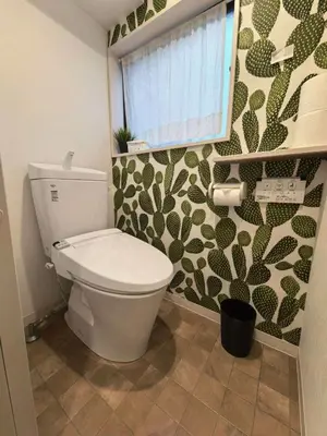 a bathroom with a white toilet and a window at AYA House in Tokyo