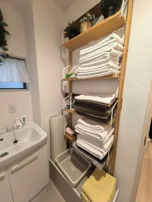 a bathroom with a rack of towels and a sink at AYA House in Tokyo