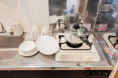 a kitchen counter with a pot on top of a stove at Mi-APT Honkomagome in Tokyo