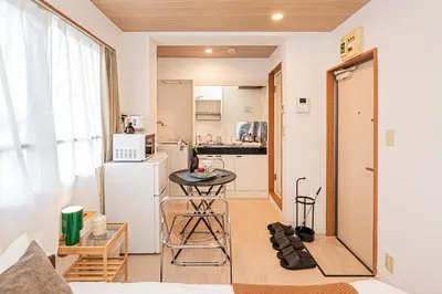 a small kitchen with a small table in a room at Mi-APT Honkomagome in Tokyo