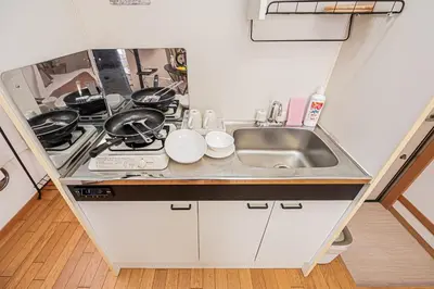 a small kitchen with a sink and a stove at Mi-APT Honkomagome in Tokyo