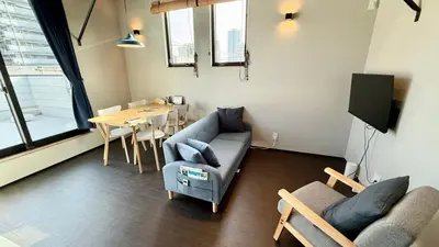 a living room with a couch and a table at SW House in Tokyo