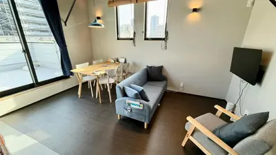 a living room with a couch and a table at SW House in Tokyo