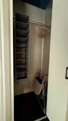 a bathroom with a shower with a toilet and shelves at SW House in Tokyo