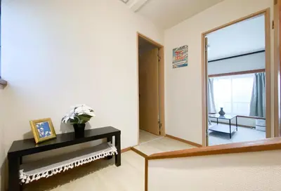 a living room with a mirror and a table at gjbbkoiwa in Tokyo