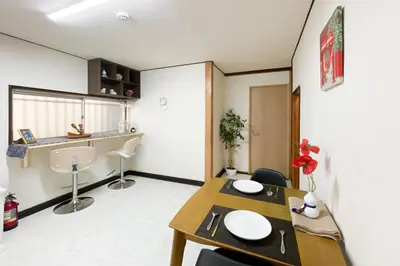 a dining room with a table and chairs in a room at gjbbkoiwa in Tokyo