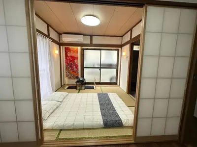 a room with a bed and a window at Akihabara, Skytree, Disney, Asakusa Temple, Traditional Japanese Ryokan, Airport Pick-up and Drop-off in Tokyo