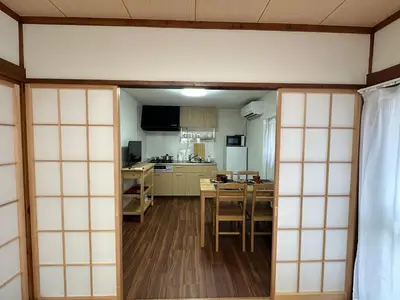 a room with a kitchen and a dining room at Akihabara, Skytree, Disney, Asakusa Temple, Traditional Japanese Ryokan, Airport Pick-up and Drop-off in Tokyo