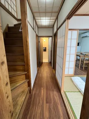 a hallway of a house with wooden floors and stairs at Akihabara, Skytree, Disney, Asakusa Temple, Traditional Japanese Ryokan, Airport Pick-up and Drop-off in Tokyo