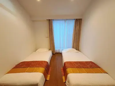 two beds in a room with a window at \u738b\u5b50Stay\u4f73 in Tokyo
