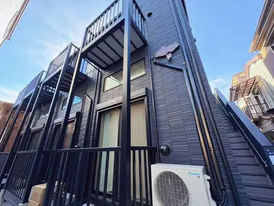 a black house with a fence and a fan at \u738b\u5b50Stay\u4f73 in Tokyo