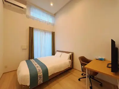 a bedroom with a bed and a desk and a computer at \u738b\u5b50Stay\u4f73 in Tokyo