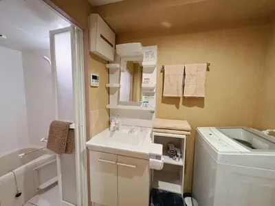 a small bathroom with a sink and a washing machine at \u738b\u5b50Stay\u4f73 in Tokyo